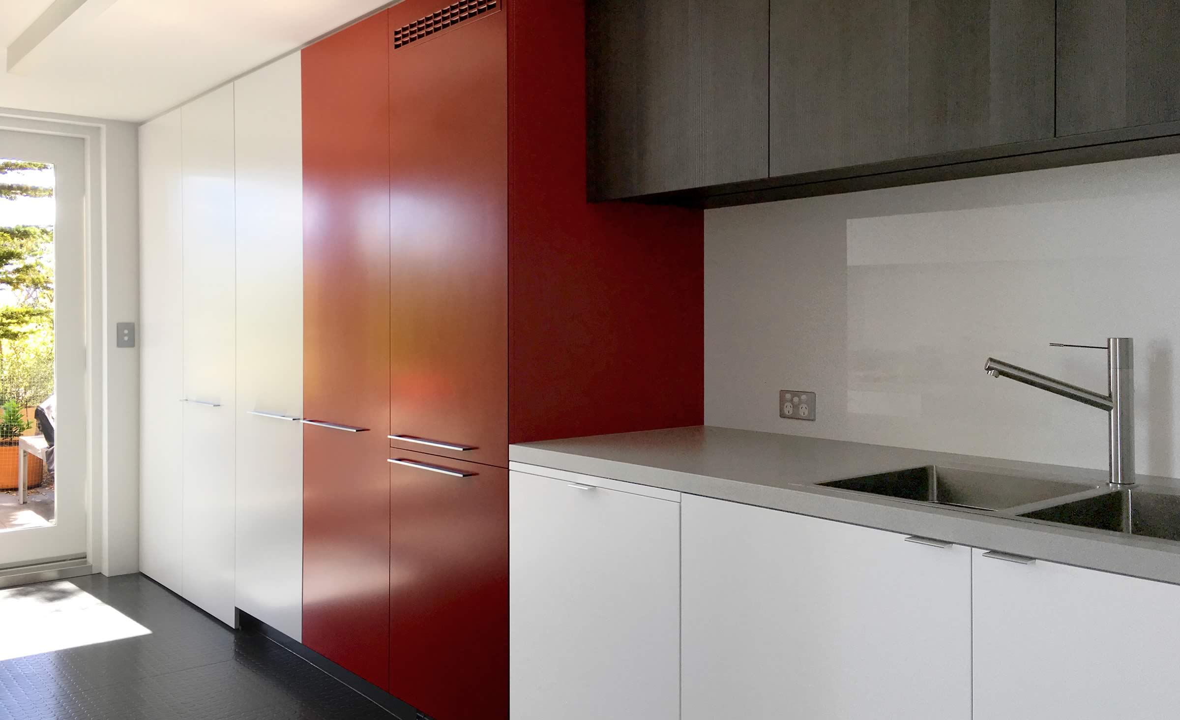 Customised kitchen joinery incorporating European laundry, two-pack paint finishes and laminates.